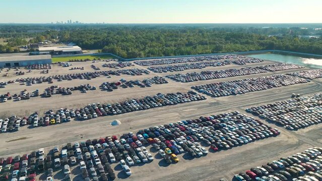 View from above of big parking lot with parked used cars after accident ready for sale. Auction reseller company selling secondhand broken vehicles for repair