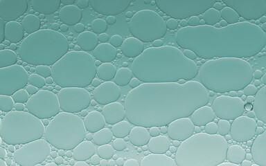 Abstract oil bubble seamless pattern on pale green background.