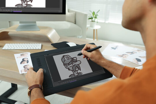 Animator using graphic tablet and computer, closeup. Illustration on screen
