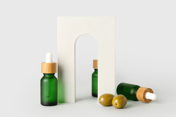 Bottles of essential olive oil and decor on white background