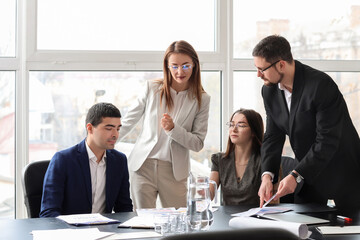 Group of people working on business plan in office