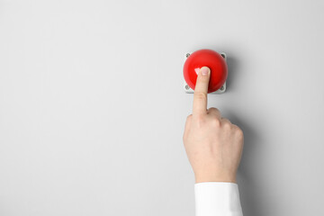 Man pressing red button of nuclear weapon on white background, top view with space for text. War...