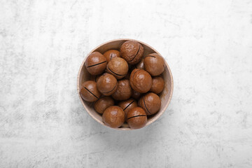 Obraz premium Delicious organic Macadamia nuts on light gray table, top view