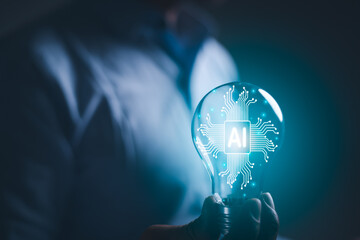 hand holding a light bulb. artificial intelligence or AI of future innovation technology concept, applying technology to business in the digital age. empowering global business AI.