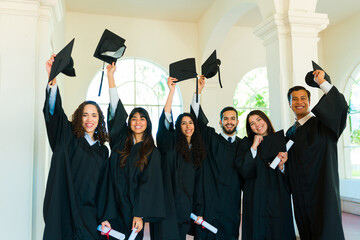 Smiling graduates excites celebrating graduating