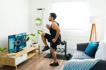 Active man working out with cardio and running at home