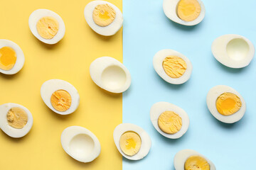 Many halves of delicious boiled eggs on blue and yellow background