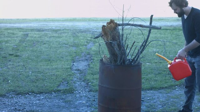 Young Man Tending Trash Can Fire in Rural Tennessee USA BMPC4K
