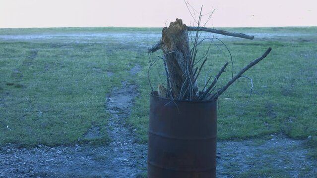Young Man Tending Trash Can Fire in Rural Tennessee USA BMPC4K