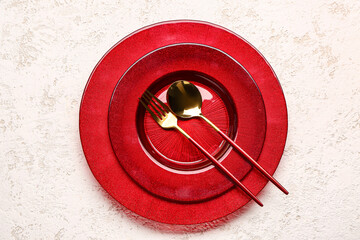 Plate with fork and spoon on white grunge background