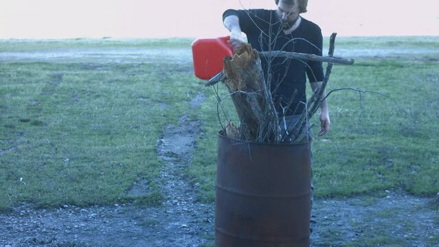 Young Man Tending Trash Can Fire in Rural Tennessee USA BMPC4K