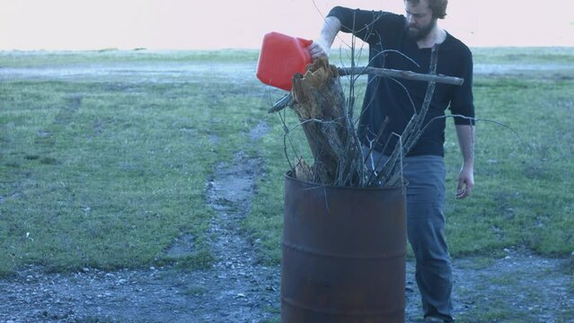 Young Man Tending Trash Can Fire in Rural Tennessee USA BMPC4K
