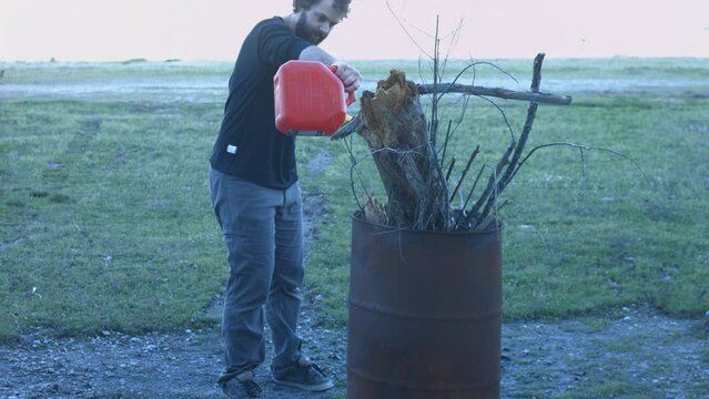 Young Man Tending Trash Can Fire in Rural Tennessee USA BMPC4K