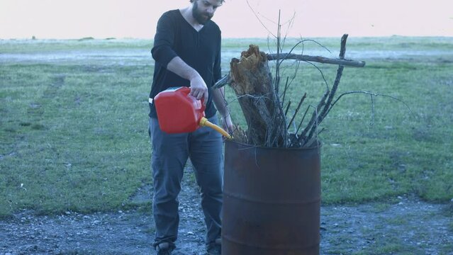 Young Man Tending Trash Can Fire in Rural Tennessee USA BMPC4K