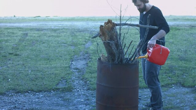 Young Man Tending Trash Can Fire in Rural Tennessee USA BMPC4K