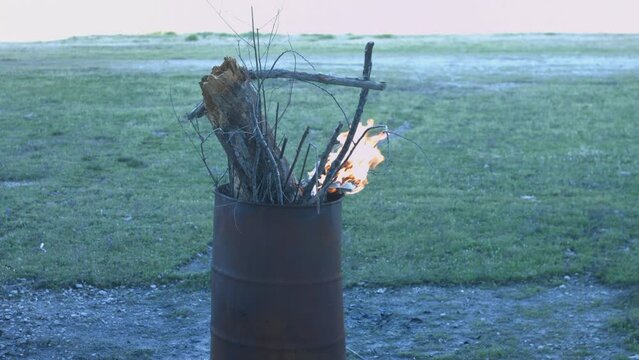 Young Man Tending Trash Can Fire in Rural Tennessee USA BMPC4K