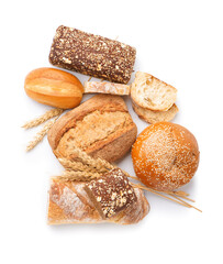 Loaves of different bread and wheat ears isolated on white background