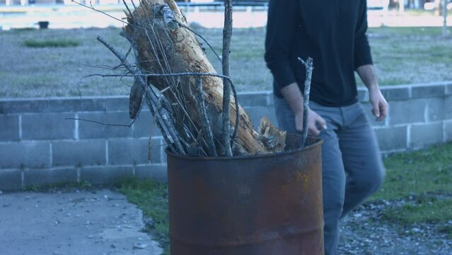 Young Man Tending Trash Can Fire in Rural Tennessee USA BMPC4K
