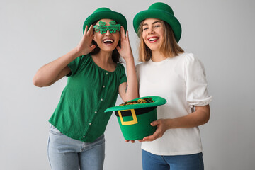 Young women with leprechaun's hat on light background. St. Patrick's Day celebration