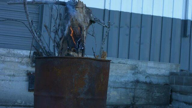 Young Person Tending Trash Can Fire in Rural Tennessee USA BMPC4K