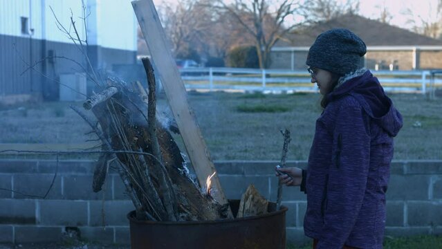 Young Person Tending Trash Can Fire in Rural Tennessee USA BMPC4K