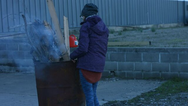Young Person Tending Trash Can Fire in Rural Tennessee USA BMPC4K