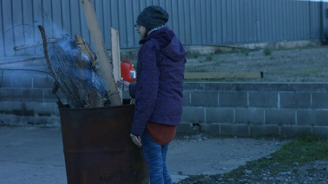Young Person Tending Trash Can Fire in Rural Tennessee USA BMPC4K