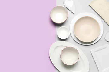 Composition with clean dishes on lilac and grey background