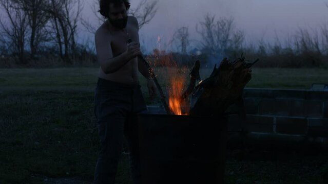 Young Man Tending Trash Can Fire in Rural Tennessee USA BMPC4K