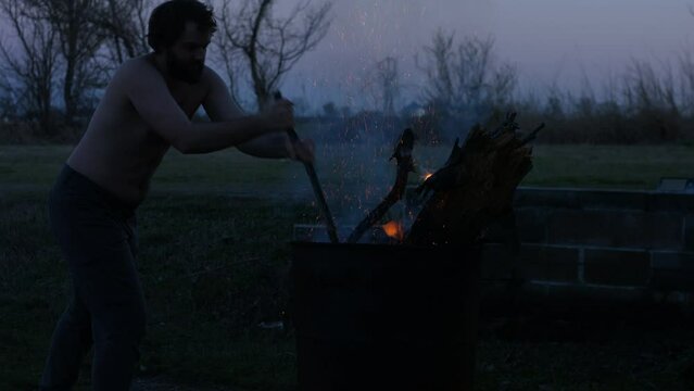 Young Man Tending Trash Can Fire in Rural Tennessee USA BMPC4K