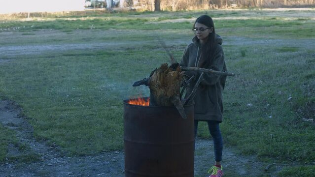 Young Woman Tends To Trashcan Fire In Rural America Countryside BMPC4K