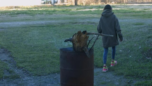 Young Woman Tends To Trashcan Fire In Rural America Countryside BMPC4K