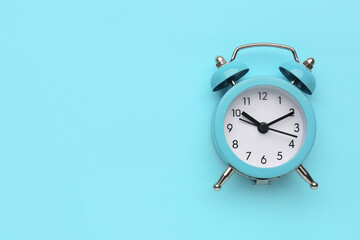 Alarm clock on blue background