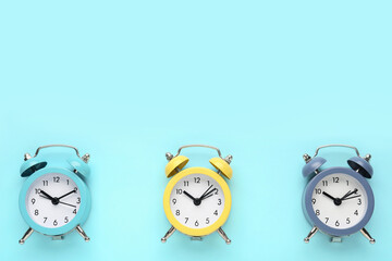 Alarm clocks on blue background