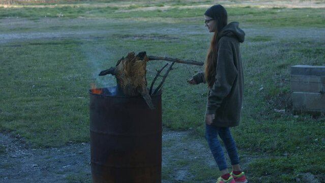 Young Woman Tends To Trashcan Fire In Rural America Countryside BMPC4K