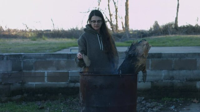 Young Woman Tends To Trashcan Fire In Rural America Countryside BMPC4K