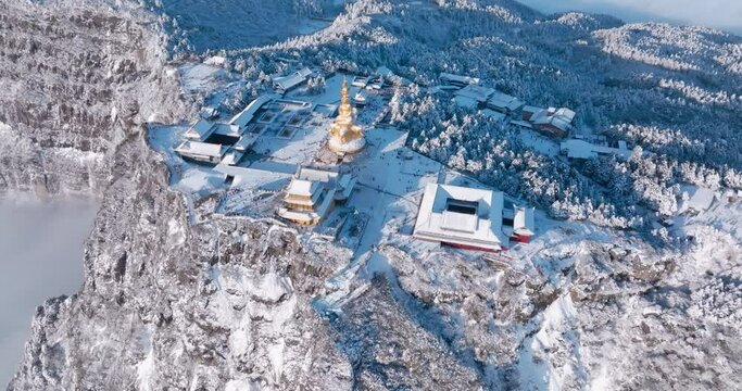 aerial top view of Emei mountain golden summit above the clouds in winter snow day