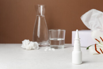 Obraz na płótnie Canvas Nasal drops on white table. Seasonal allergy concept