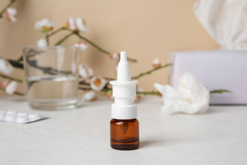 Obraz na płótnie Canvas Nasal drops on white table. Seasonal allergy concept