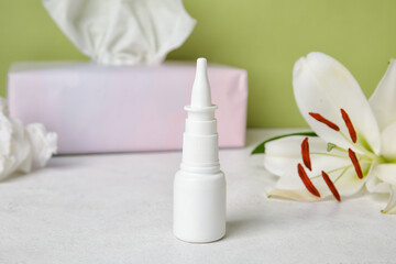 Fototapeta na wymiar Nasal drops on white table. Seasonal allergy concept