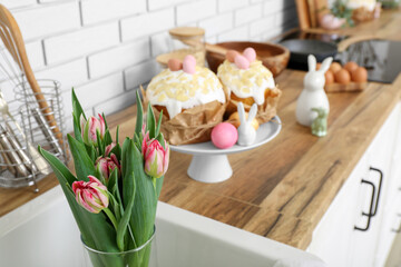 Vase with tulip flowers in modern kitchen decorated for Easter celebration