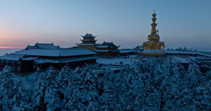 Aerial view of Emei mountain golden summit in the snow winter sunrise morning with sea of clouds Emeishan Buddhist temple