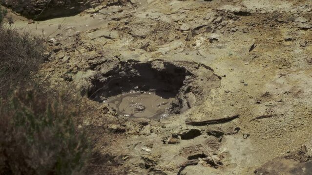 Brown Puddle of hot volcanic mud boiling hole and ground - Quality 4K Footage