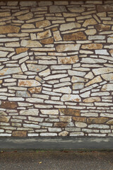 Rock stone wall building siding sidewalk