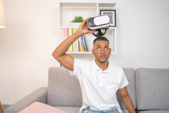 Fototapeta Young man, taking off virtual reality glasses