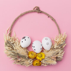 Easter eggs on pastel pink Background. Creative minimal layout with copy space. Flat lay concept.