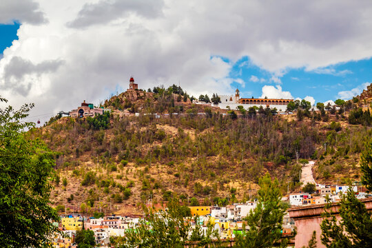 building in top of hill with blue sky and  white clouds, bufa hill in zacatecas 