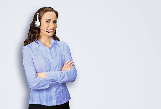 Contact Call Center Service. Customer support, female sales agent. Caller answering phone operator or businesswoman in blue cloth. Image of smiling woman in headset, isolated grey gray background.