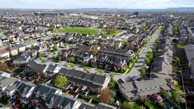 Orbiting over a park and Milton houses on a sunny spring morning.