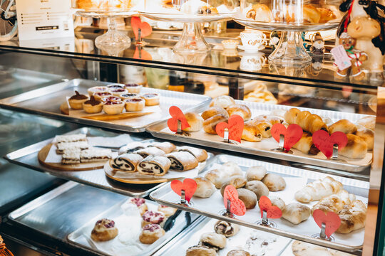 Modern bakery with different types of bread, cakes and buns. Various types of cakes in a glass showcase of a pastry shop